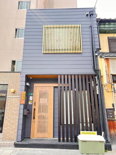a building with a door and a bench in front of it at 寧安居 in Osaka