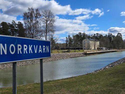 a blue street sign next to a river at Vänerport Lakefront Hotell in Mariestad