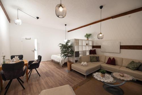 a living room with a couch and a bed at Hinterhaus in Herdwangen