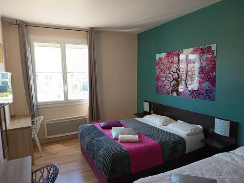 a bedroom with two beds and a painting on the wall at Hôtel De La Gare Périgueux in Périgueux