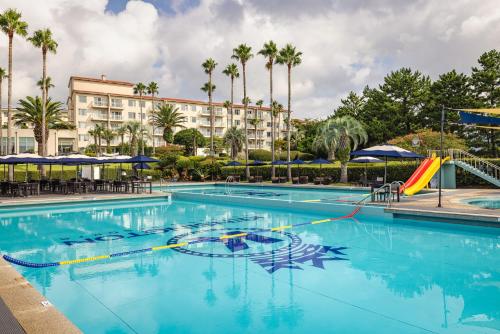 a swimming pool with a slide in front of a hotel at Kensington Resort Seogwipo in Seogwipo