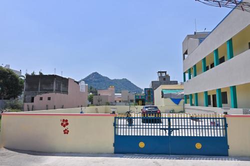 a blue fence in front of a building at Kavitha Family Home stay TVM in Tiruvannāmalai