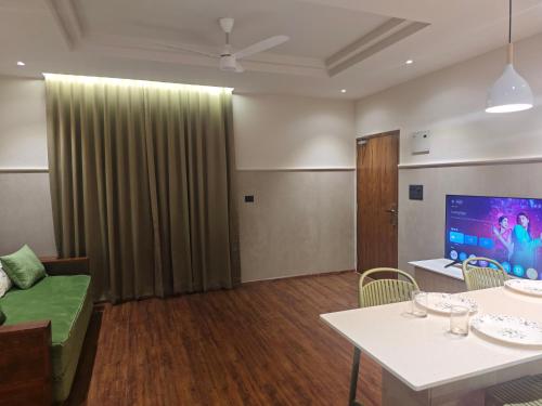 a living room with a couch and a table at Gulzar 1BHK Service Apartment, kannur in Kannur