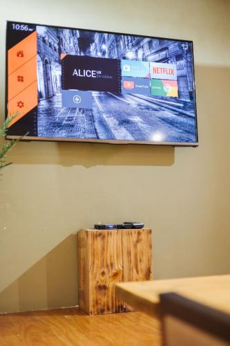 a flat screen tv hanging on a wall at Old Quarter 6 Senses 3Br Hoan Kiem in Hanoi