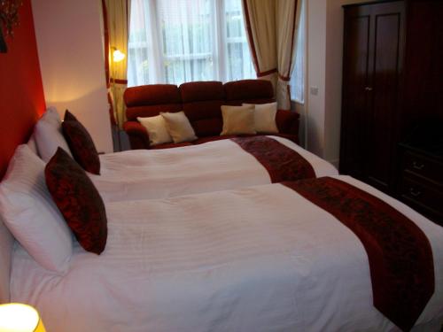 Ένα ή περισσότερα κρεβάτια σε δωμάτιο στο Gate Lodge Guest House