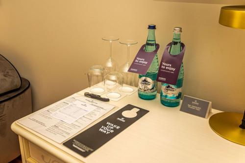 a table with two bottles of wine and glasses on it at Radisson Collection Morina Hotel, Tirana in Tirana