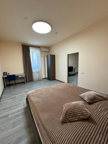 a bedroom with a large bed with two pillows on it at Family Guest House in Yerevan