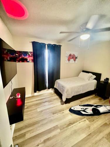 a bedroom with a bed and a ceiling fan at Goshen Golf Stay Peaceful 4BR Retreat Near Courses in Augusta