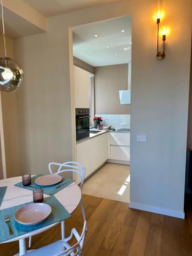 a kitchen and dining room with a table and chairs at MilanLife Apartments - DTown Charme in Milan