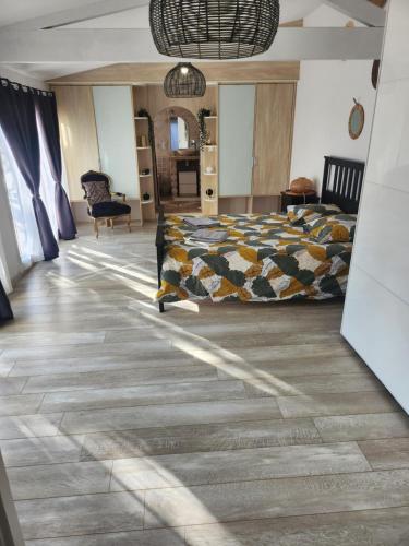 a bedroom with a bed and a floor at La villa de Fleury in Fleury
