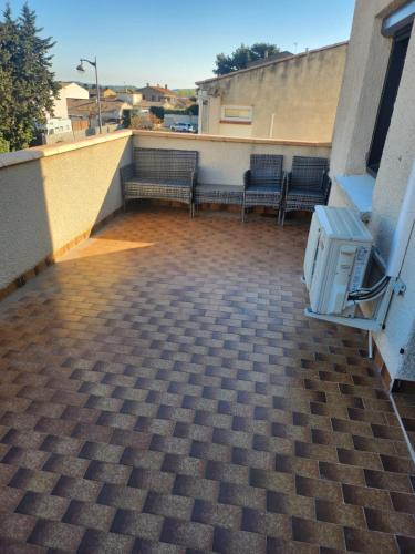 a balcony with benches on the side of a building at La villa de Fleury in Fleury
