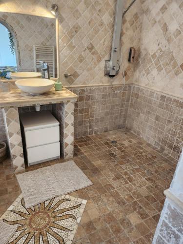 a bathroom with a sink and a shower at La villa de Fleury in Fleury