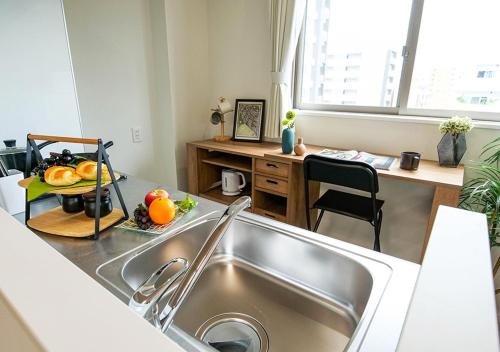 a kitchen with a sink and a counter top at Asakusabashi Condominium Hotel in Tokyo