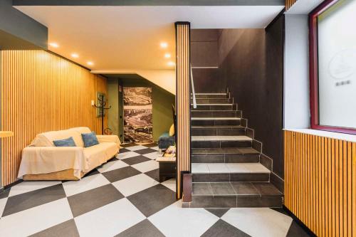 a bedroom with a bed and a checkered floor at Arena Albaro House in Genoa