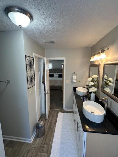 a bathroom with two sinks and a large mirror at Cozy Stay in Hephzibah in Hephzibah
