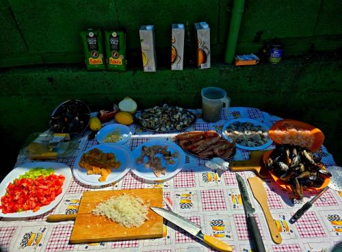 a table with many plates of food on it at RINCON DO MAR ArenaBlanca in A Guarda