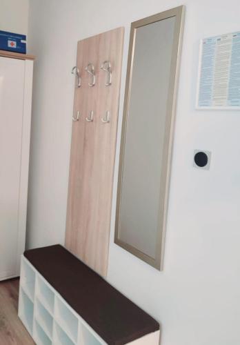 a bathroom with a mirror on the wall and a bench at Urban Retreat in Osijek