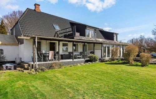 a black and white house with a yard at 2 Bedroom Nice Apartment In Sydals in Østerby