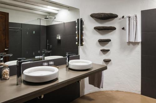 a bathroom with two sinks and a mirror at Kamezí Boutique Hotel Villas in Playa Blanca