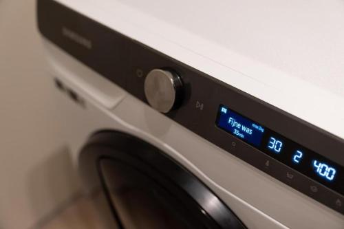 a close up of a washing machine with a clock at Unique Penthouse Near City Center And Park in Roosendaal