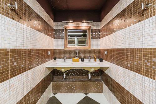a bathroom with two sinks and a mirror at Arena Albaro House in Genoa