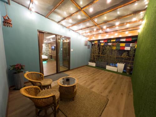 a room with chairs and a table and a mirror at Satori Apartment in Kathmandu