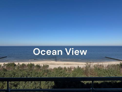 a sign that reads ocean view on a beach at Sunset Waves - Right at the beach in Dziwnówek