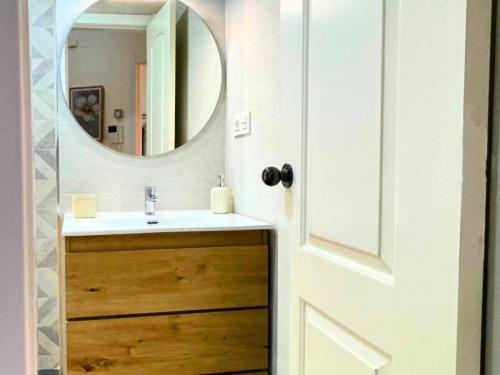 a bathroom with a sink and a mirror at Home4u Acogedor apartamento en Maracena in Maracena