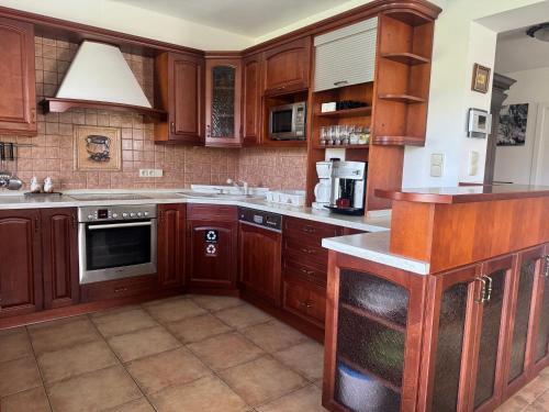 a kitchen with wooden cabinets and a stove top oven at Dům Stašov in Stašov