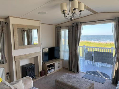 a living room with a view of the ocean at 256 North Park in North Seaton