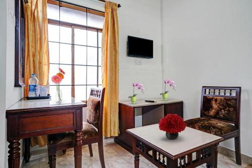 a living room with a desk and a chair at Palette - Pagoda Resorts in Cochin