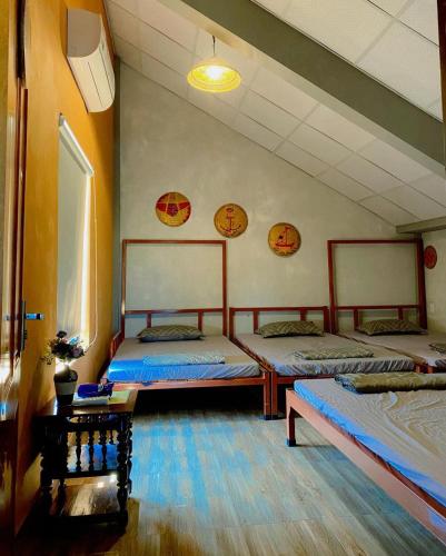 Кровать или кровати в номере Cối Xay Gió Homestay Quảng Bình