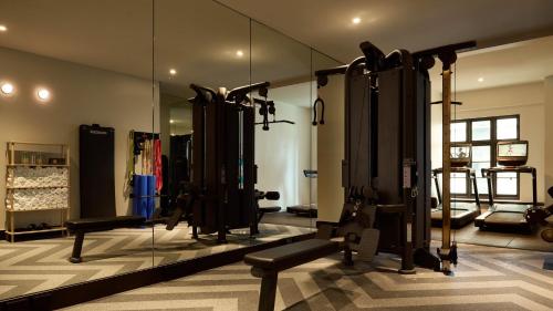 a gym with a mirror and lots of equipment at Hotel Indigo Auckland by IHG in Auckland