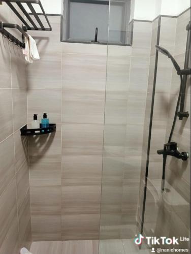 a shower with a glass door in a bathroom at Nanic Homes Rio Vista in Marimbeti
