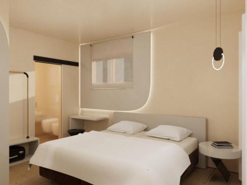 a bedroom with a white bed and a window at Hotel Diana in Malcesine