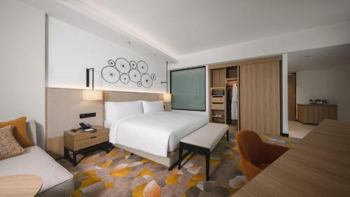 a hotel room with a bed and a kitchen at Holiday Inn & Suites Penang Prai by IHG in Bukit Mertajam