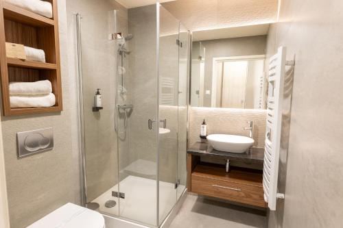 a bathroom with a glass shower and a sink at Kocierz Resort in Targanice