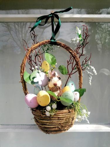 a basket filled with easter eggs in a window at Villa Irbe in Jūrmala