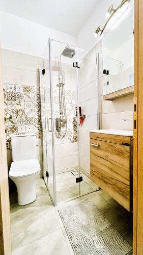 a bathroom with a toilet and a glass shower at Villa Miramare in Georgioupolis