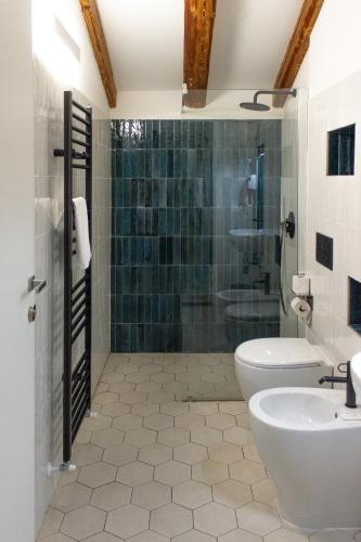 a bathroom with a shower and a toilet and a sink at Casali Hostel in Trieste