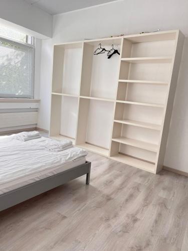 a bedroom with white shelves and a bed at Bright, comfy, industrial looking in Fällanden