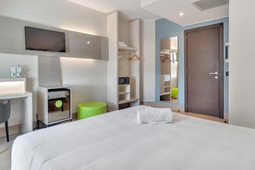 a bedroom with a white bed and a tv at B&B Hotel Milano San Siro in Milan