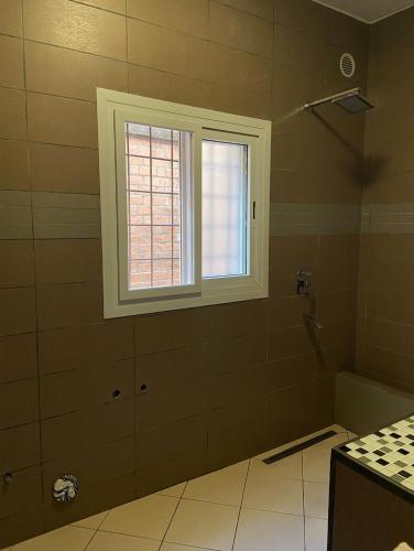a bathroom with a window and a shower at Appart Cozy Ivandry dans villa in Antananarivo