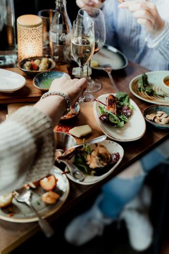 a group of people sitting at a table with plates of food at Vann Spa Hotell & Konferens in Brastad