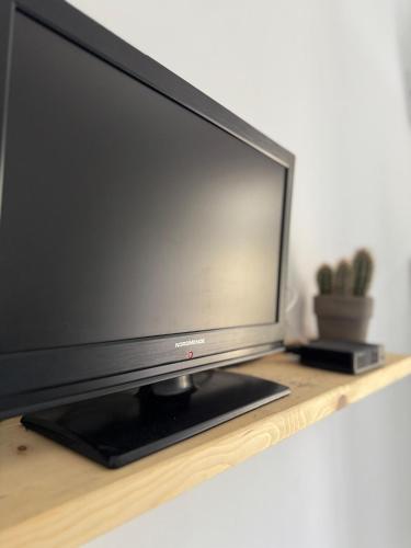 a flat screen tv sitting on a wooden shelf at ZenZone House in La Spezia