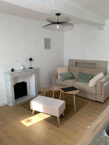 a living room with a couch and a fireplace at Les bons Enfants 5 in Rouen