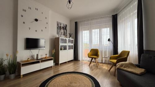 a living room with a couch and a tv at Art-déco in Pécs
