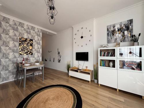 a living room with a table and a tv at Art-déco in Pécs