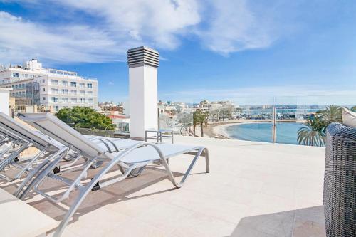 a balcony with lounge chairs and a view of the ocean at Apartments Beach 4U - Can Pastilla in Can Pastilla