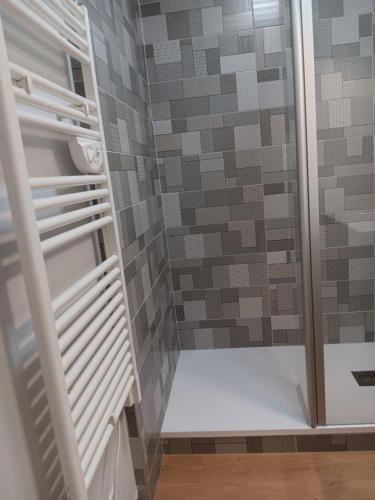a walk in shower with a glass door in a bathroom at Appart Sion face mer in Sion-sur-lʼOcéan